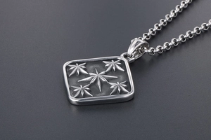 Detailed macro view of vintage titanium steel square pendant with star engravings