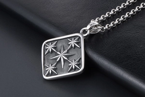Macro shot of vintage titanium steel square pendant with embossed octagonal stars detail