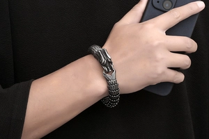 Close-up of vintage dragon scale bracelet for men with intricate metal texture and clasp