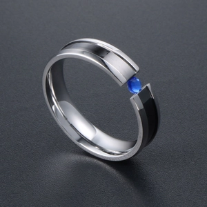 Polished titanium steel ring with black inlay and a sparkling blue zircon stone
