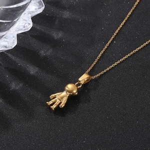 Golden titanium steel 3D astronaut pendant necklace on sparkling black background