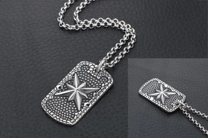 Detailed close-up of vintage stainless steel military dog tag with an 8-pointed star relief