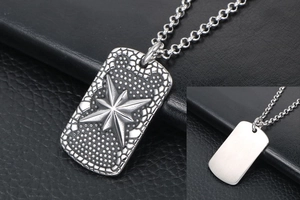 Macro detail of vintage rectangle pendant with star relief and brushed metal surface