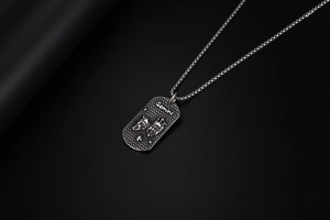 Detailaufnahme von Gemini Anhänger in Vintage Silber mit Reliefmaske und Stahlkette