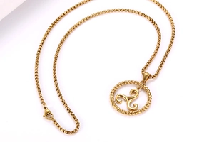 Detailed macro of golden titanium steel triskelion pendant with woven rope edge detail