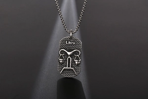 Macro shot of Libra zodiac pendant with vintage silver finish and ball chain necklace