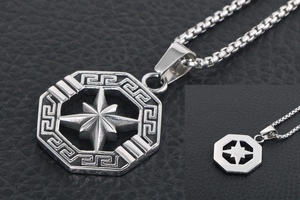 Macro view of octagon star pendant with Greek meander patterns and silver steel finish