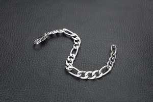 Polished silver Figaro link chain bracelet for men with secure lobster clasp detail