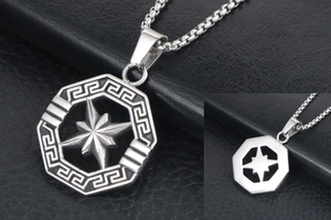 Macro detail of octagonal star pendant with Greek key pattern and silver box chain