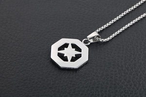 Close-up of silver titanium steel octagonal pendant with hollow star on leather base