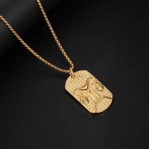 Golden Libra zodiac necklace with square link chain and textured pendant on black background