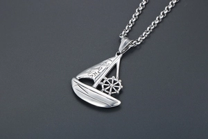 Close-up of silver sailboat pendant necklace with engraved Chinese characters