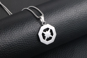 Macro shot of silver hexagon star pendant on box chain over black leather background