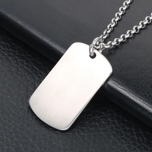 Brushed stainless steel dog tag necklace for men and women on black leather texture