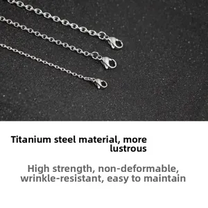 Detailed macro view of high-polish titanium steel chain featuring a durable lobster clasp
