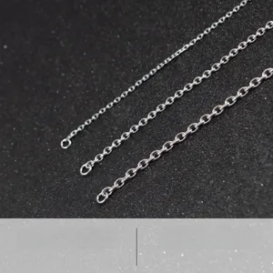 Macro detail of three silver stainless steel cross chains with four-sided cut finish