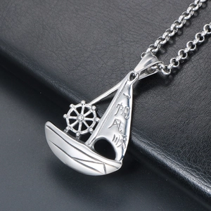 Silver sailing boat necklace pendant with smooth sailing engraving on black background