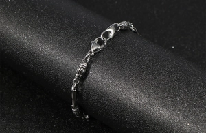 Macro shot of silver stainless steel cylindrical beads and lobster clasp detail