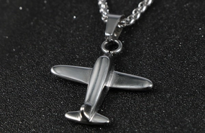 Macro shot of silver stainless steel P51 Mustang aircraft pendant with twisted rope chain