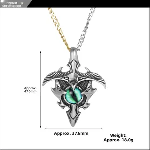 Macro view of vintage evil eye pendant showing measurements and detailed green dragon eye stone