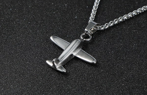 Macro view of polished stainless steel P-51 Mustang aircraft pendant with wheat chain