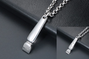 Detailed macro view of vintage razor-shaped pendants with intricate engraved patterns