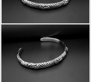 Detailed macro view of vintage silver cuff bracelet with engraved gothic cross patterns