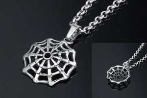 Macro detail of silver spider web pendant with round O-chain on black reflective background