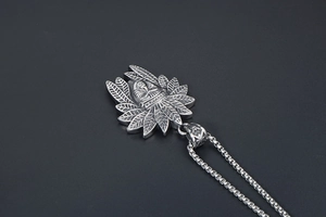 Detail of vintage steel Indian tribal portrait pendant with detailed feather headpiece