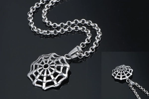 Macro detail of polished stainless steel spider web pendant on a thick rolo chain