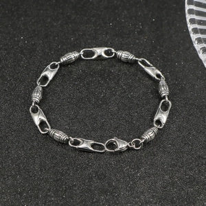 Sleek stainless steel bracelet with textured cylindrical beads and polished links