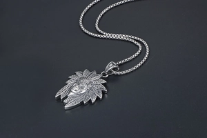 Macro view of vintage Indian chief portrait pendant with detailed feather headgear