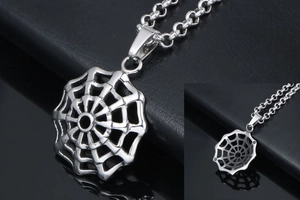 Close-up of polished silver spider web pendant with chunky round link steel chain