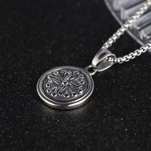 Polished silver stainless steel round pendant necklace with sunburst relief pattern