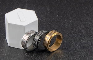 Macro view of Nordic Viking Rune rings set in gold, black, and silver stainless steel