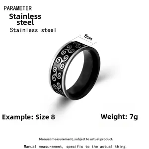Macro view of 8mm stainless steel ring featuring a black enamel Triskele pattern