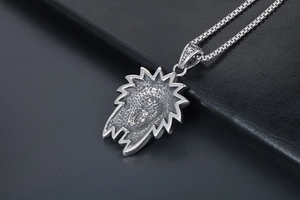 Macro shot of retro stainless steel lion head pendant with honeycomb textured back