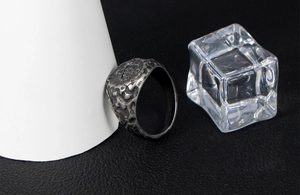 Macro shot of men's vintage stainless steel ring with irregular meteorite texture finish