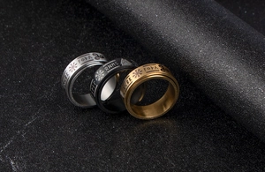 Macro shot of three-color stainless steel spinner rings featuring Viking rune engravings