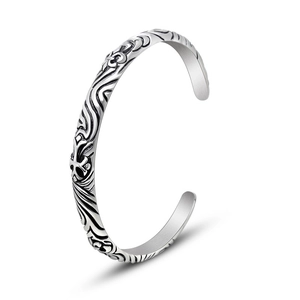 Retro silver open bangle featuring gothic cross relief and intricate totem engravings