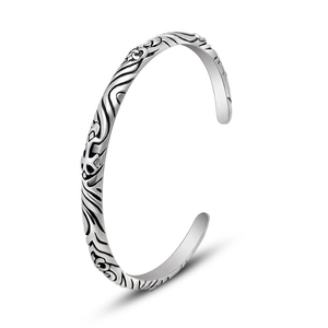 Vintage totem silver cuff bracelet with intricate floral carvings and open adjustable design