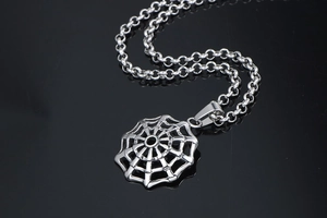 Macro shot of silver titanium spider web pendant with durable round link chain