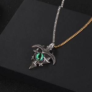Gothic titanium pendant necklace featuring a green evil eye and eagle wing design for men