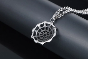 Macro shot of silver steel spider web pendant with gothic hollow structure