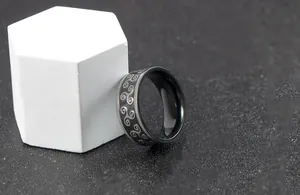 Detailed close-up of a stainless steel ring featuring Celtic triskelion spiral engravings