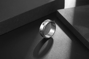 Macro shot of stainless steel spinner ring featuring repetitive cute turtle pattern engravings