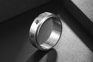 Detailed macro view of brushed stainless steel ring with black sea turtle engravings
