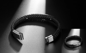 Detailed macro view of woven black leather bracelet with magnetic silver metal clasp