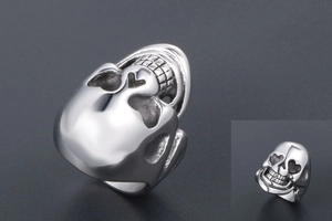 Macro shot of punk style skull ring with heart-shaped eyes in polished titanium steel