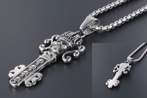 Detailed view of punk style skull key pendant with crown and vintage silver finish